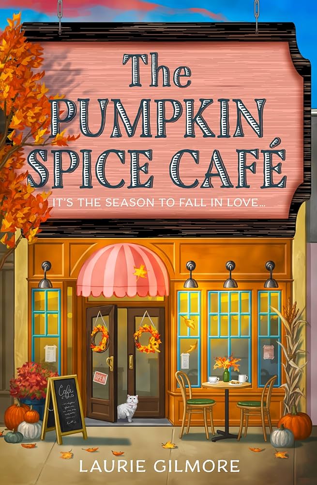 Illustration of 'The Pumpkin Spice Café' with autumn decorations and a cat outside.