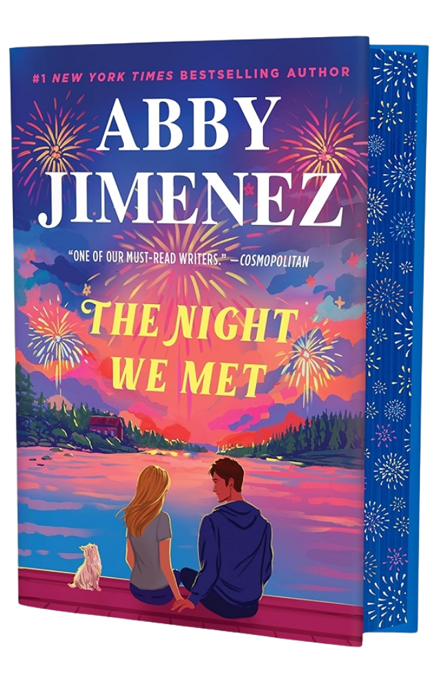 Book cover of 'The Night We Met' by Abby Jimenez with a couple and dog on a dock at sunset.
