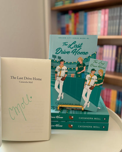 Book titled 'The Last Drive Home' on a shelf with other books.