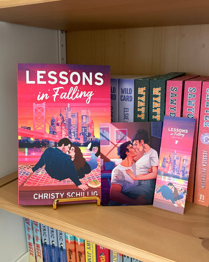 Book titled 'Lessons in Falling' on a bookshelf with other books.