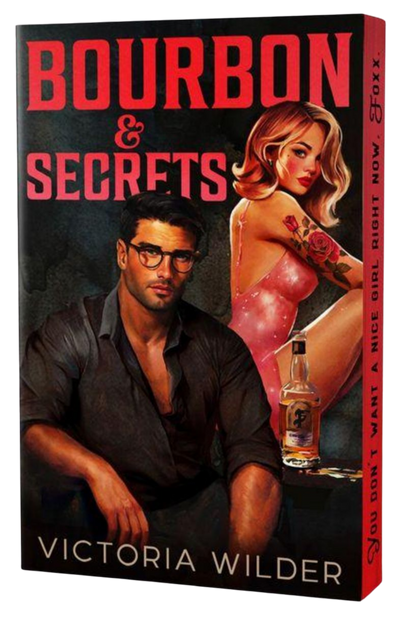 Book cover of 'Bourbon & Secrets' by Victoria Wilder featuring a man and woman with a bottle of bourbon.