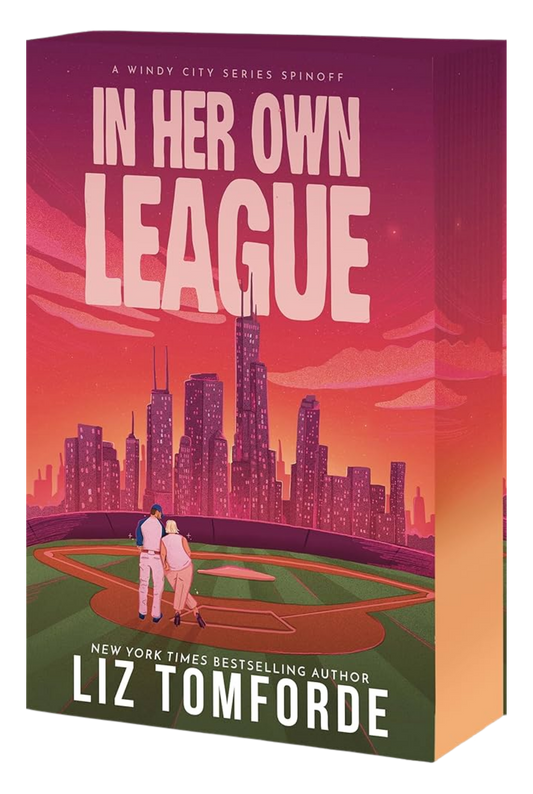 Book cover of 'In Her Own League' by Liz Tomforde with a city skyline and two people on a baseball field.