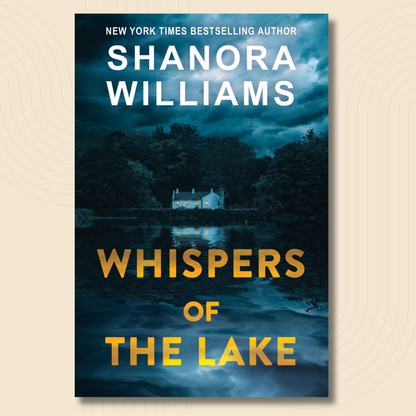 Book cover for 'Whispers of the Lake' by Shanora Williams, featuring a dark blue nighttime lake scene with a small house reflected in the water and large gold title text, shown on a light beige background.
