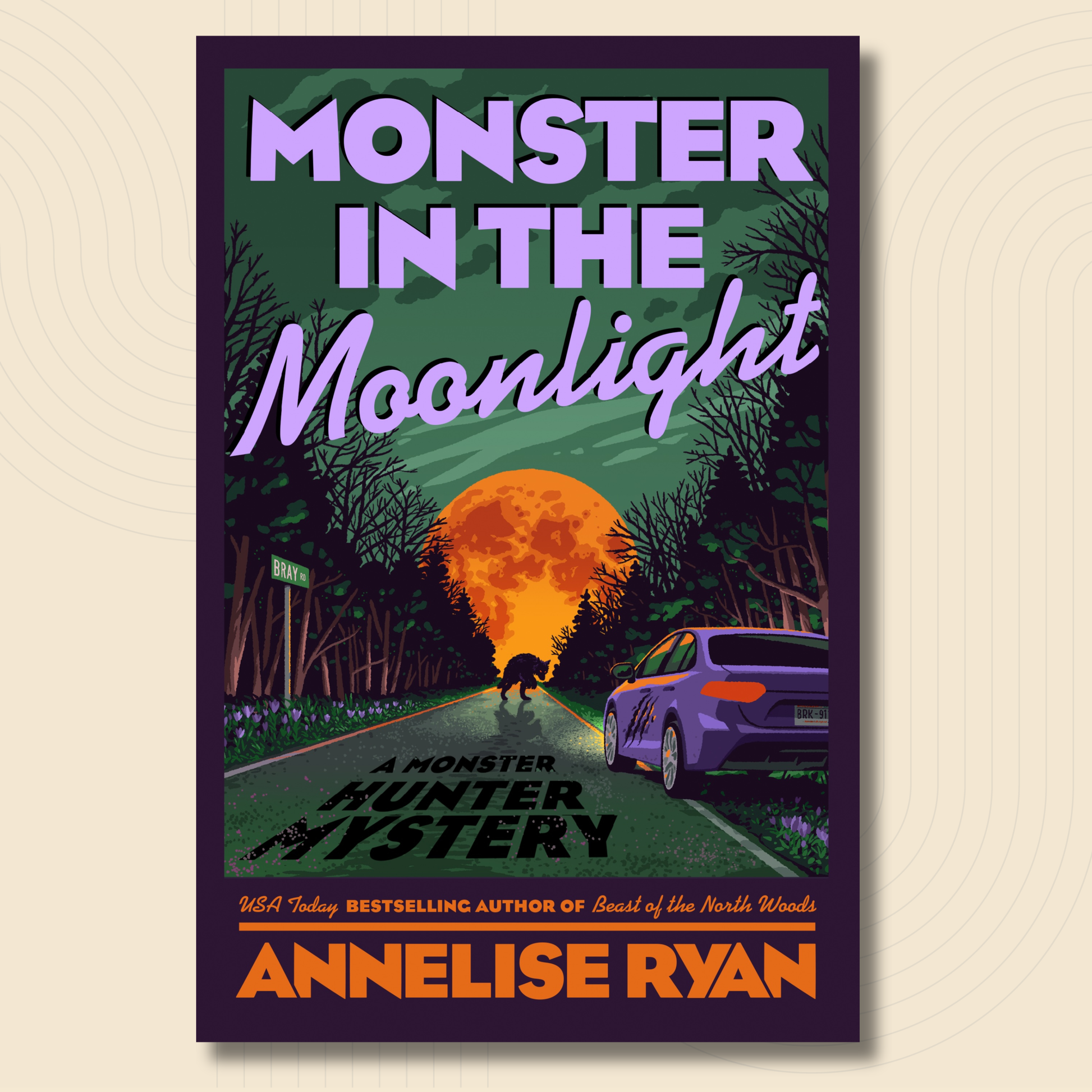 Book cover for 'Monster in the Moonlight' by Annalise Ryan, featuring a dark illustrated forest road with a giant orange full moon, a small black cat silhouette, and a purple car, set against a light beige background.