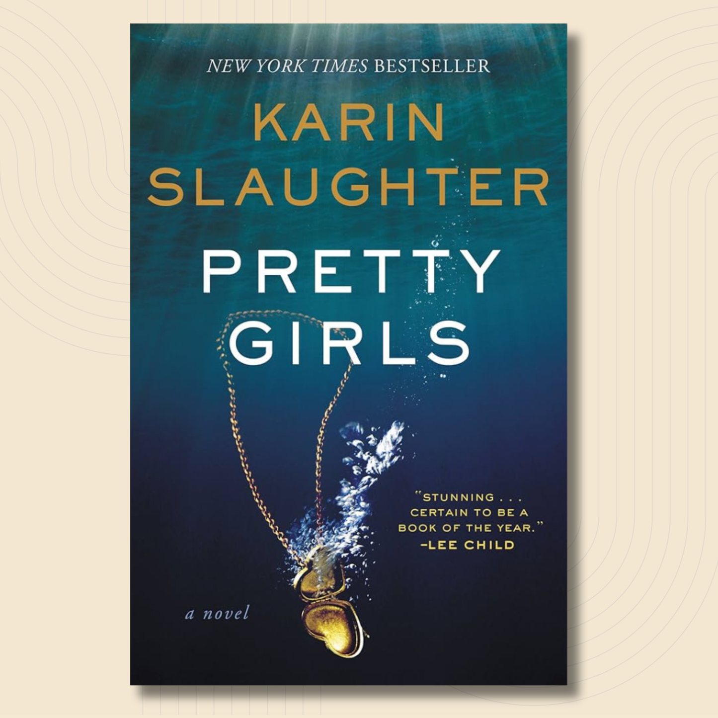 Book cover for the novel 'Pretty Girls' by Karin Slaughter, featuring a dark blue underwater design with a gold heart-shaped pendant and white and gold text.