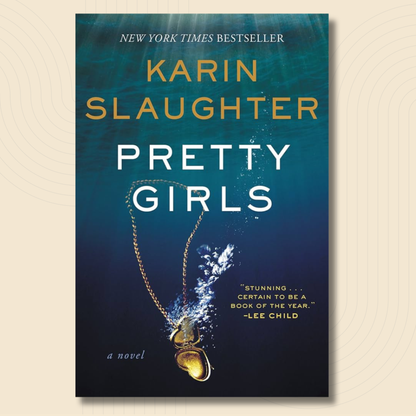 Book cover for the novel 'Pretty Girls' by Karin Slaughter, featuring a dark blue underwater design with a gold heart-shaped pendant and white and gold text.
