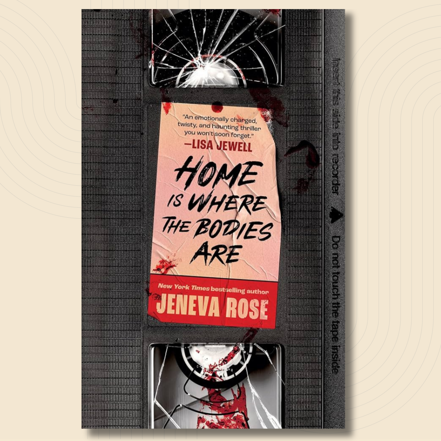 A VHS-style book cover for the thriller 'Home Is Where The Bodies Are' by Jeneva Rose, shown against a light beige background. The cover mimics a black video tape with a torn pink label, cracked glass, and blood splatter details.
