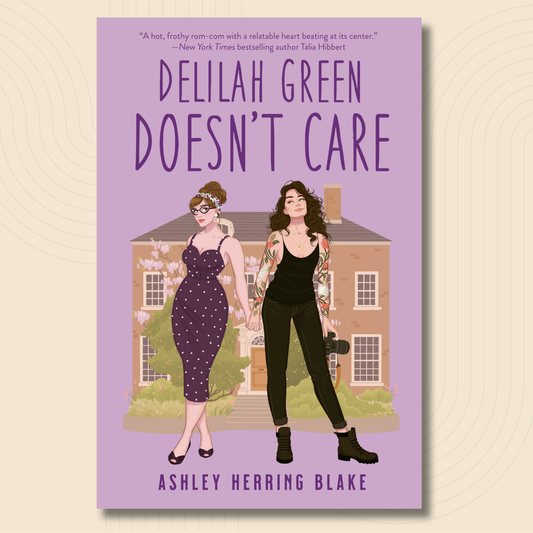 Book cover for 'Delilah Green Doesn't Care' by Ashley Herring Blake, featuring an illustrated purple house and two women standing in front of it on a lavender background.