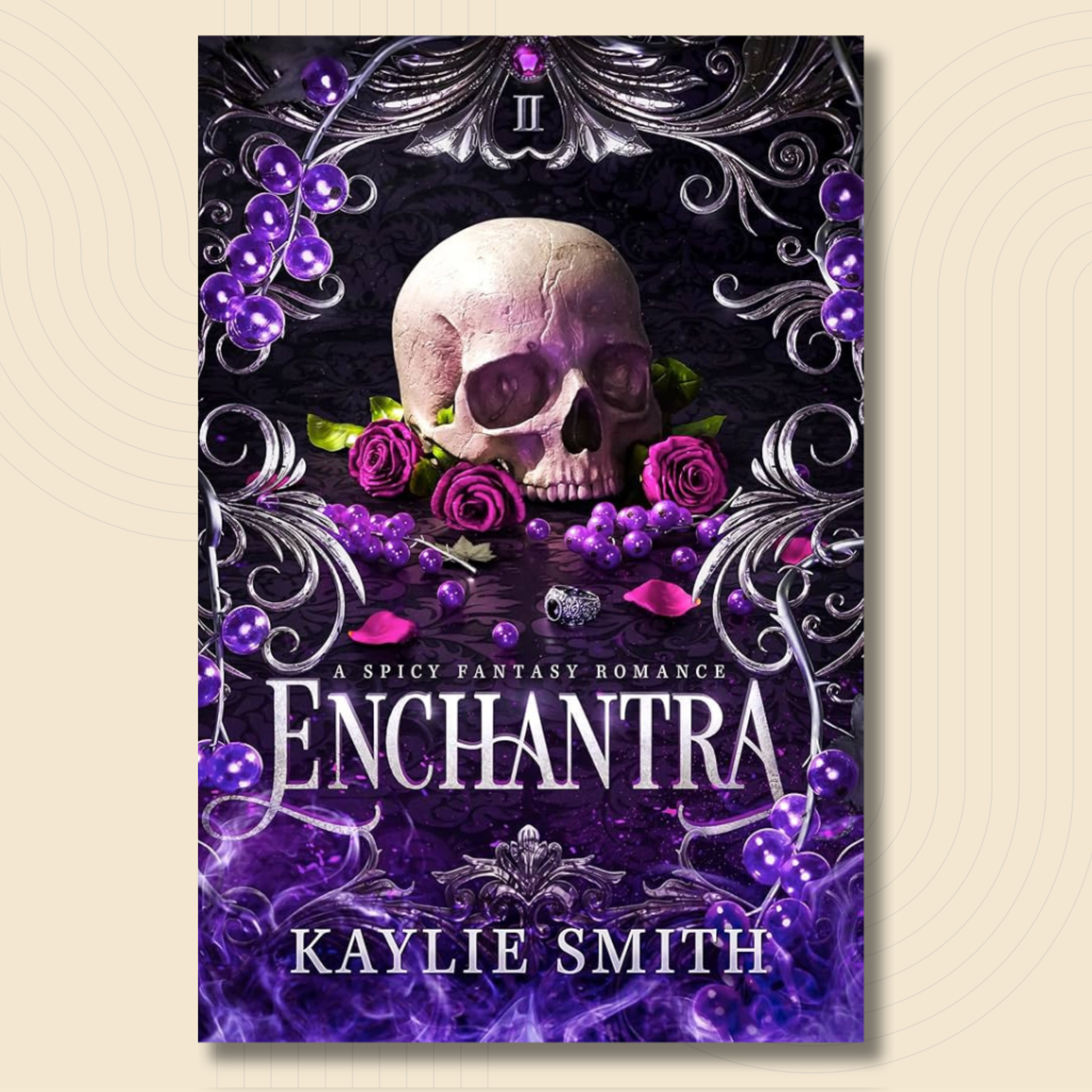 Book cover for 'Enchantra' by Kaylie Smith, featuring a skull surrounded by purple roses and grapes, framed by ornate silver filigree on a dark background.
