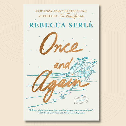 Book cover for 'Once and Again' by Rebecca Serle, featuring a cream background with gold and teal typography and a blue coastal house illustration, shown against a warm beige background with subtle concentric circle patterns.