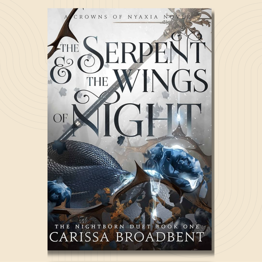 Book cover for 'The Serpent & the Wings of Night' by Carissa Broadbent, featuring a dark blue serpent, glowing blue roses, and ornate gothic typography on a smoky gray background, centered on a light beige textured backdrop.