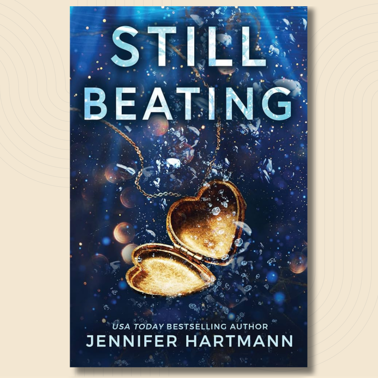 Book cover for 'Still Beating' by Jennifer Hartmann, featuring a dark blue underwater scene with a glowing gold heart-shaped locket and white title text.