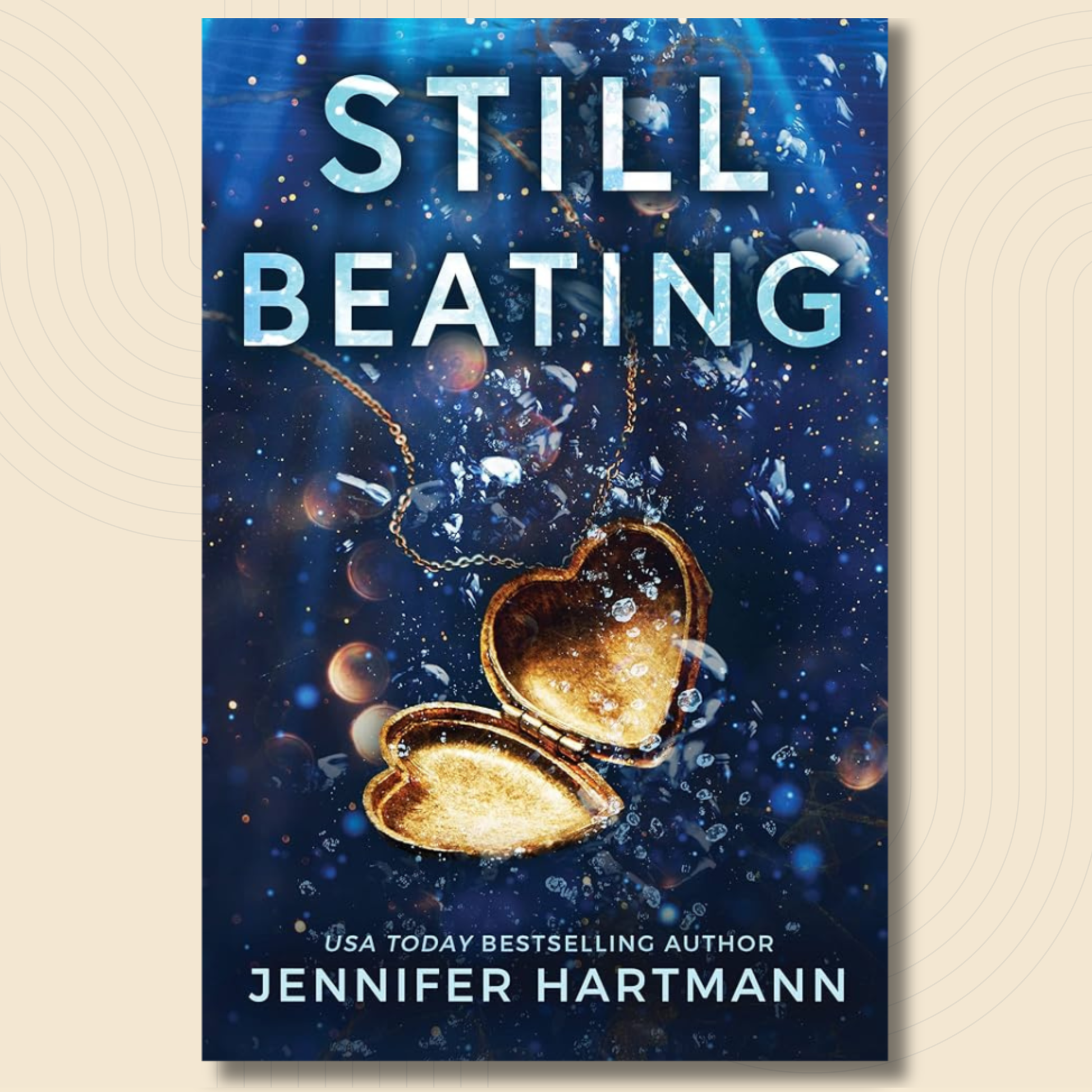 Book cover for 'Still Beating' by Jennifer Hartmann, featuring a dark blue underwater scene with a glowing gold heart-shaped locket and white title text.