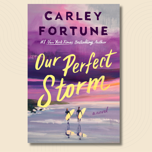 Book cover for 'Our Perfect Storm' by Carley Fortune, featuring a colorful painted beach scene with two surfers walking into the water and large yellow title text, shown on a light beige background with a soft shadow.