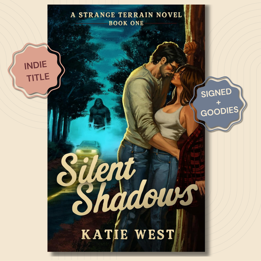 Book cover for 'Silent Shadows' by Katie West, shown as a vertical novel cover with a couple embracing in a dark forest at night and a glowing figure in the distance. Two decorative badges on the sides read 'INDIE TITLE' and 'SIGNED + GOODIES'.