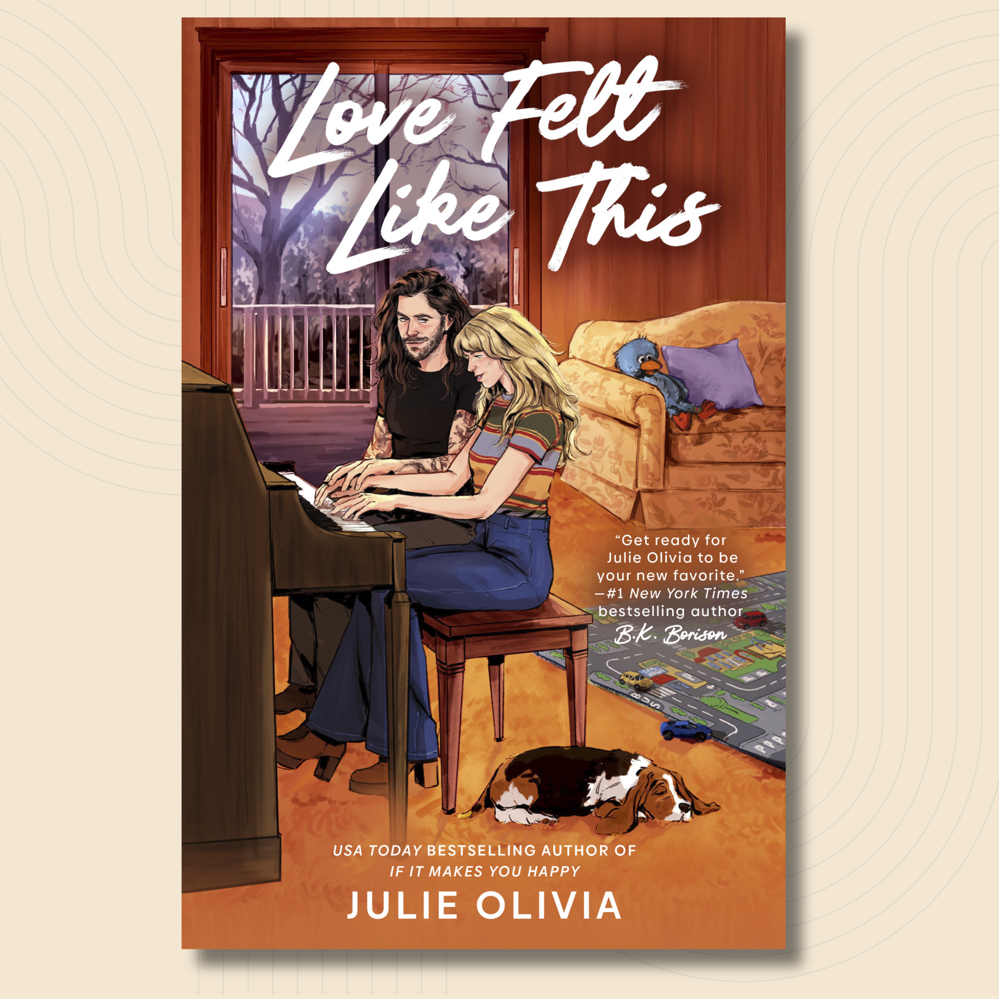 Book cover for 'Love Felt Like This' by Julie Olivia, featuring an illustrated couple sitting together in a warmly lit living room with a piano, couch, and dog.