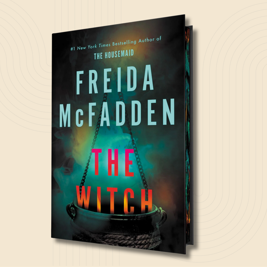 The book cover of 'The Witch' by Freida McFadden, shown at a three-quarter angle against a light beige background with subtle concentric circle patterns. The cover features a dark, moody design with a black witch's cauldron and glowing teal and pink text.