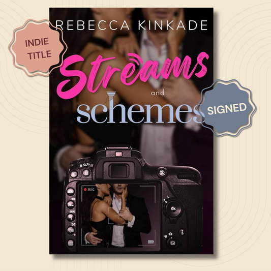 Book cover for 'Streams and schemes' by Rebecca Kinkade, featuring a black camera with a couple on screen, pink and blue title text, and badge overlays reading 'Indie Title' and 'Signed'.