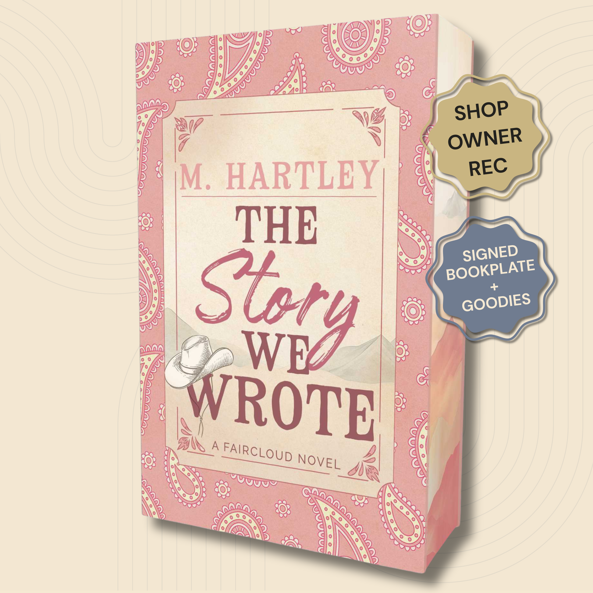 Book cover for 'The Story We Wrote' by M. Hartley, featuring a pink paisley design with a cream central label and a small white cowboy hat illustration.