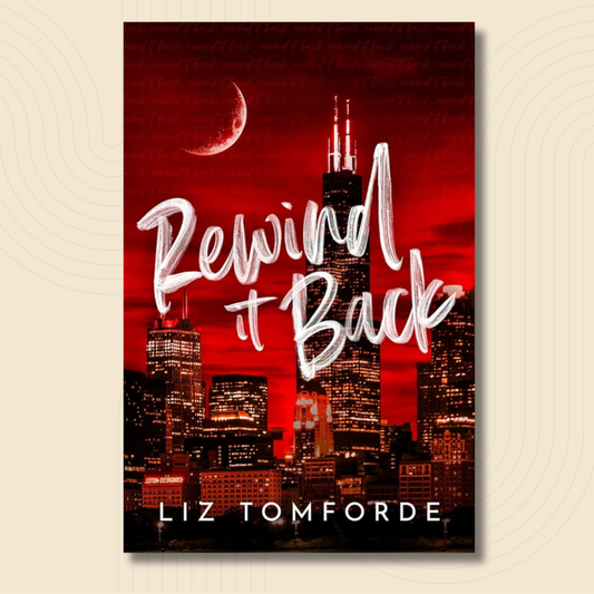 Book cover for 'Rewind It Back' by Liz Tomforde, featuring a red Chicago skyline with a crescent moon and large white script title text, shown against a light beige background.